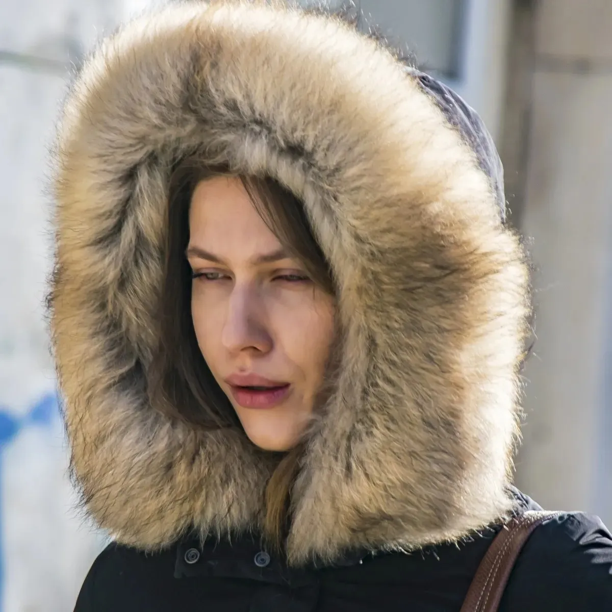 Close-up of a woman framed by a fur-lined hood